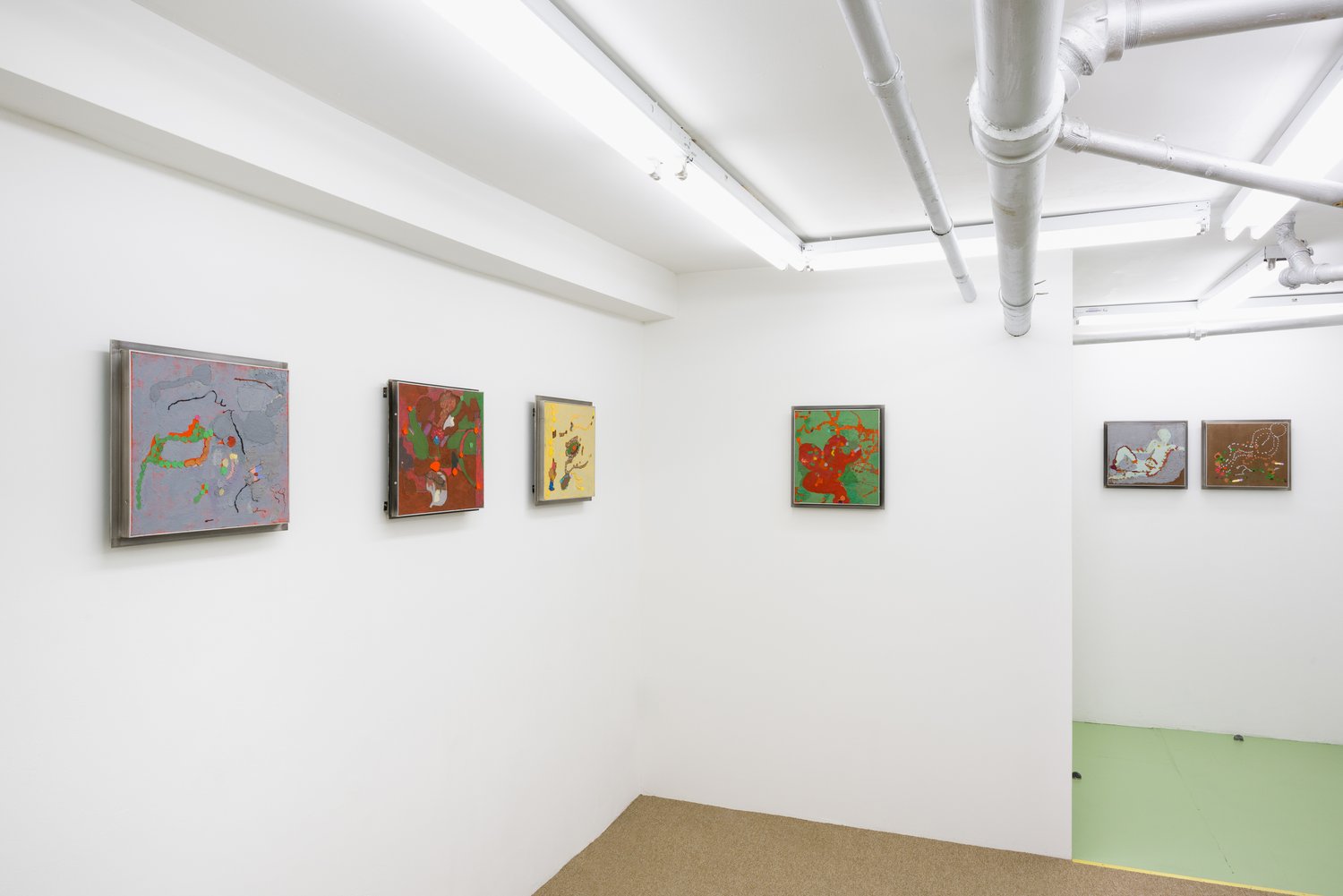 An installation view of the paintings in an exhibition.